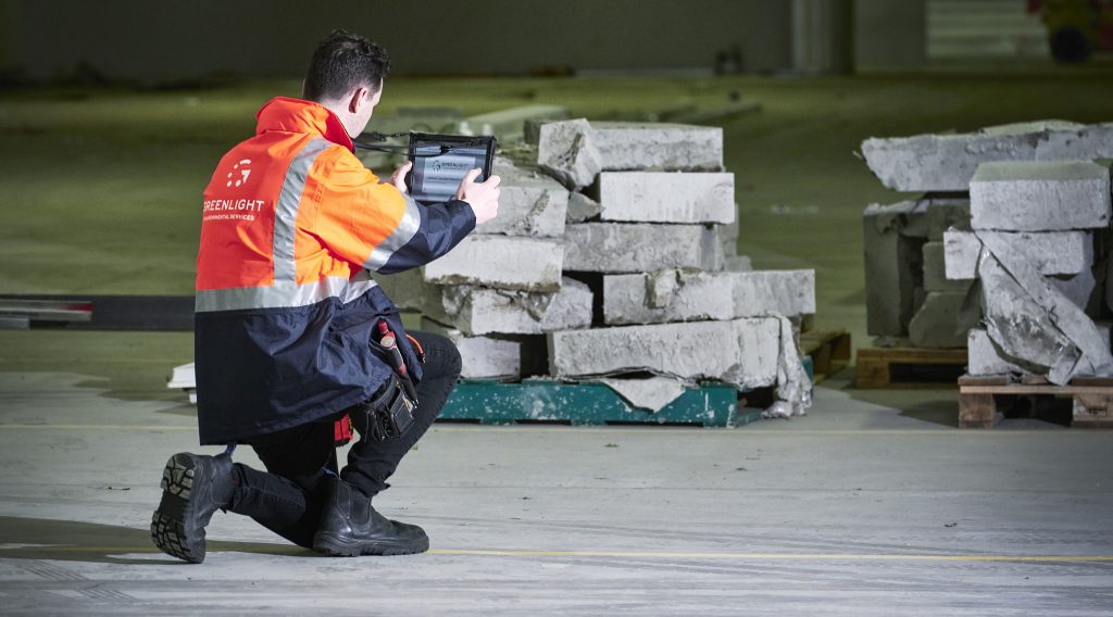 view of asbestos inspector taking images of potential asbestos